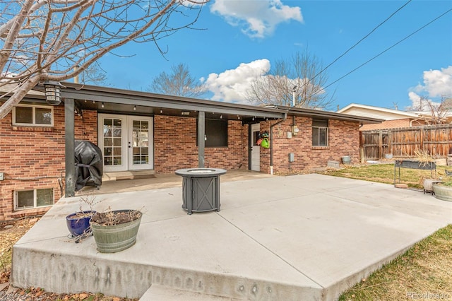 6614 Everett St, Arvada, CO 80004 - rear view of house with a patio area, french doors, and brick siding
