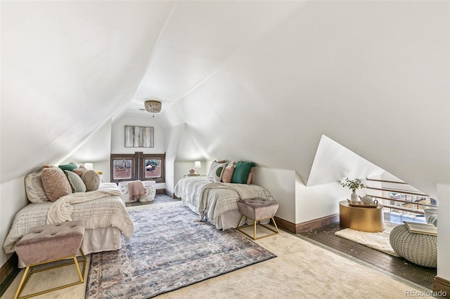 bedroom featuring vaulted ceiling and baseboards