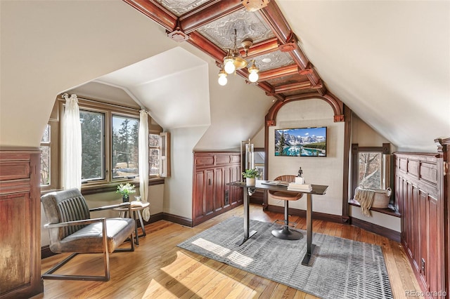 home office with lofted ceiling, light wood-style floors, baseboards, and coffered ceiling