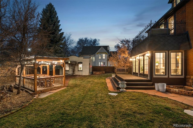 view of yard with a deck and french doors