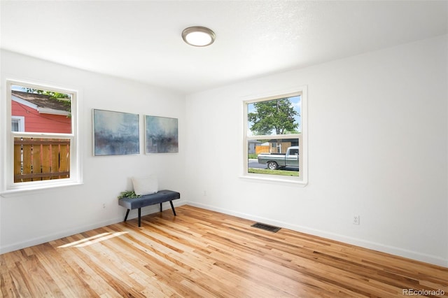 1180 Newark St, Aurora, CO 80010 - unfurnished room with healthy amount of natural light, wood finished floors, and baseboards
