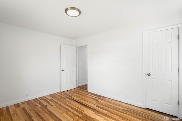 1180 Newark St, Aurora, CO 80010 - unfurnished room with baseboards and light wood-type flooring