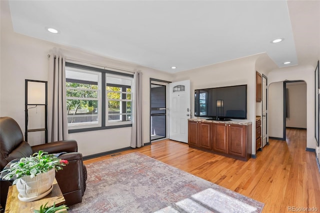 living room featuring visible vents, light wood-style flooring, and recessed lighting