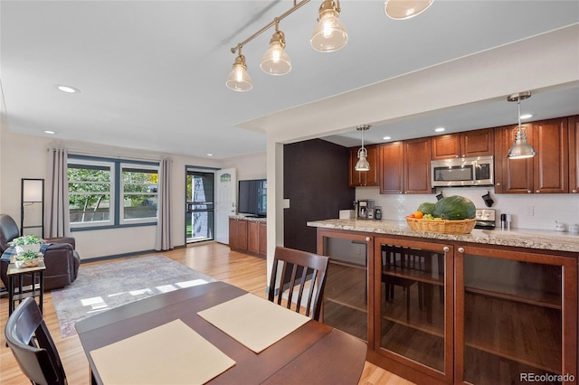 dining area featuring light wood-style floors, wine cooler, and recessed lighting