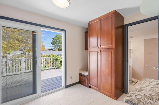 entryway featuring light tile patterned flooring and baseboards