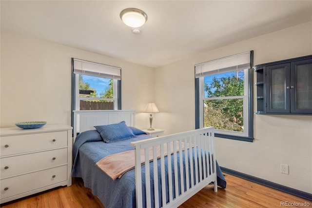 bedroom featuring wood finished floors and baseboards