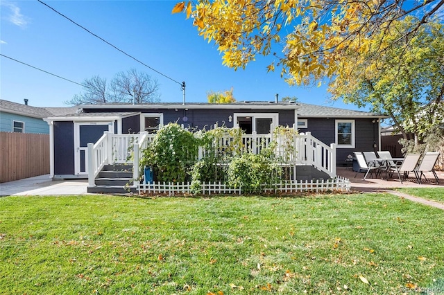 back of house with a patio, an outbuilding, fence, a deck, and a yard