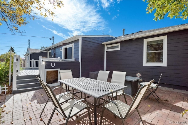 view of patio featuring outdoor dining space and a wooden deck