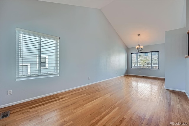 20521 E Bellewood Pl, Aurora, CO 80015 - unfurnished room with a chandelier, light wood-style floors, baseboards, and high vaulted ceiling