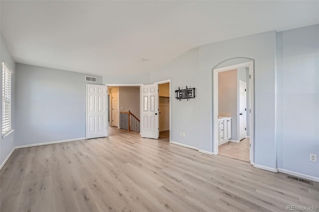 20521 E Bellewood Pl, Aurora, CO 80015 - unfurnished bedroom featuring light wood-style flooring, baseboards, a spacious closet, and ensuite bathroom