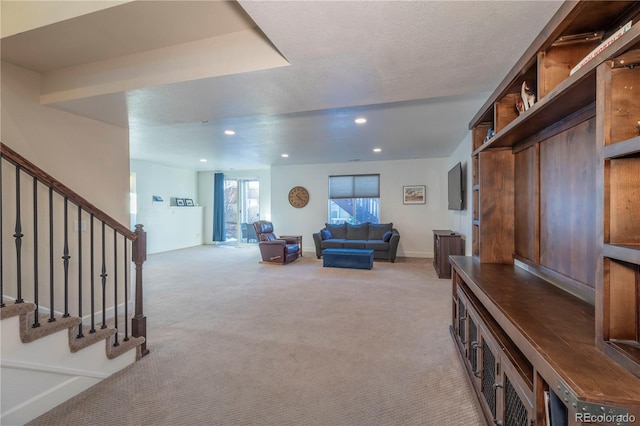 living room featuring light carpet and a textured ceiling