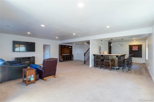 carpeted living room featuring bar