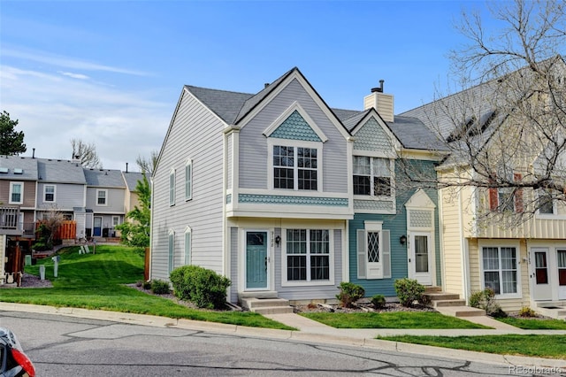 9188 W Ontario Dr, Littleton, CO 80128 - victorian-style house featuring a front lawn and a chimney