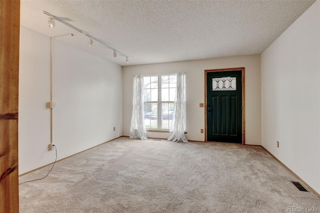 9188 W Ontario Dr, Littleton, CO 80128 - entrance foyer with track lighting, carpet floors, and a textured ceiling