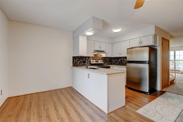9188 W Ontario Dr, Littleton, CO 80128 - kitchen featuring appliances with stainless steel finishes, under cabinet range hood, decorative backsplash, light wood-type flooring, and a peninsula