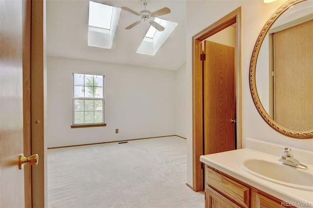 9188 W Ontario Dr, Littleton, CO 80128 - bathroom with a skylight, vaulted ceiling, vanity, and ceiling fan