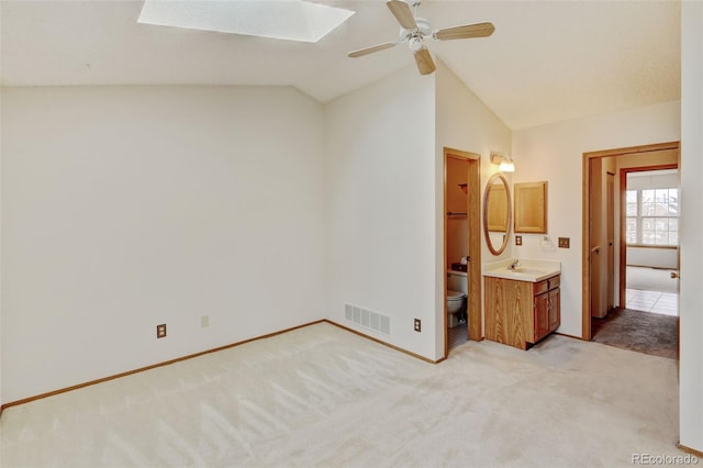 9188 W Ontario Dr, Littleton, CO 80128 - unfurnished bedroom with a sink, light colored carpet, lofted ceiling, baseboards, and a skylight