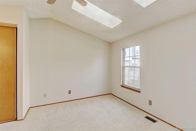 9188 W Ontario Dr, Littleton, CO 80128 - unfurnished room with a skylight, carpet, lofted ceiling, baseboards, and ceiling fan