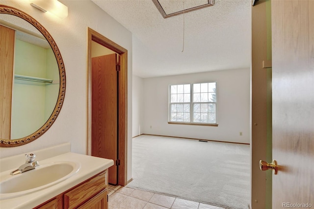 9188 W Ontario Dr, Littleton, CO 80128 - bathroom with tile patterned flooring, vanity, and a textured ceiling