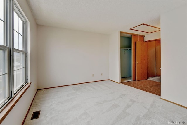 9188 W Ontario Dr, Littleton, CO 80128 - empty room with plenty of natural light, carpet, baseboards, and a textured ceiling