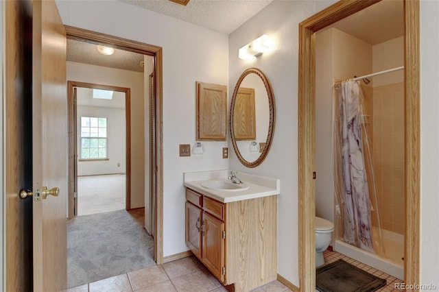 9188 W Ontario Dr, Littleton, CO 80128 - bathroom with a textured ceiling, toilet, curtained shower, tile patterned floors, and vanity