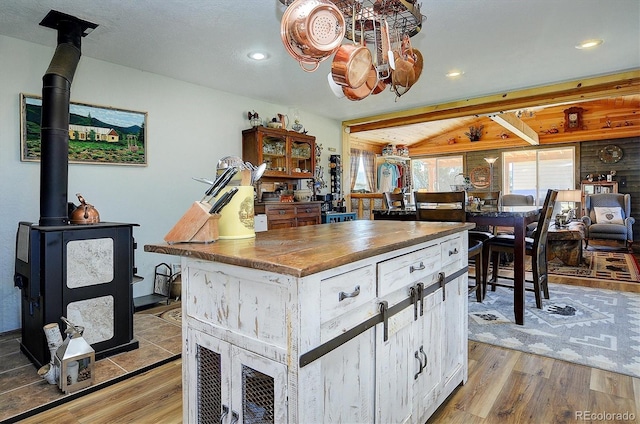 1106 Hull Ave, Westcliffe, CO 81252 - kitchen with light wood-style floors, recessed lighting, white cabinetry, a kitchen island, and butcher block counters