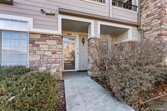 doorway to property featuring stone siding