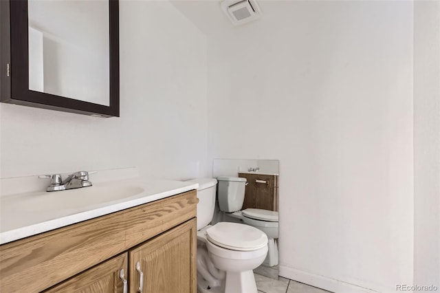 bathroom with tile patterned floors, vanity, and toilet