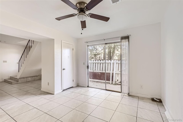 spare room featuring ceiling fan and light tile patterned floors