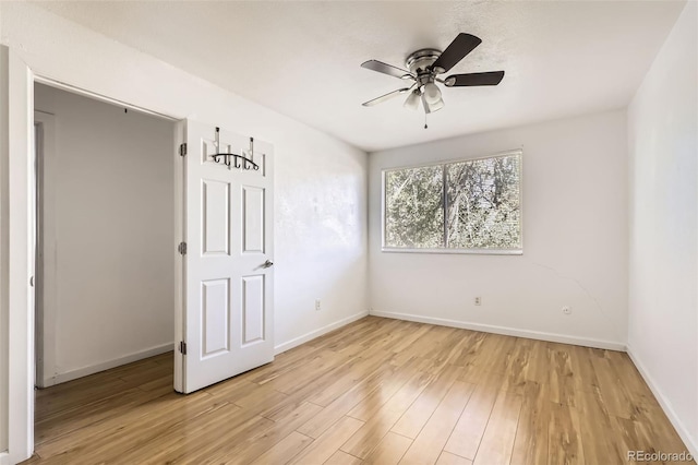 spare room featuring ceiling fan and light wood-type flooring