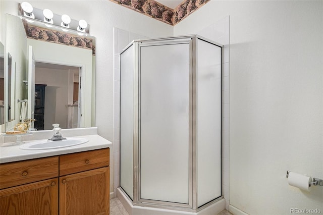 bathroom featuring vanity and a shower with shower door