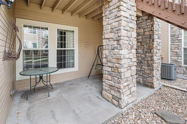 exterior space with central AC unit and a patio