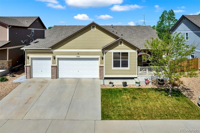 craftsman inspired home featuring brick siding, an attached garage, driveway, and a front lawn