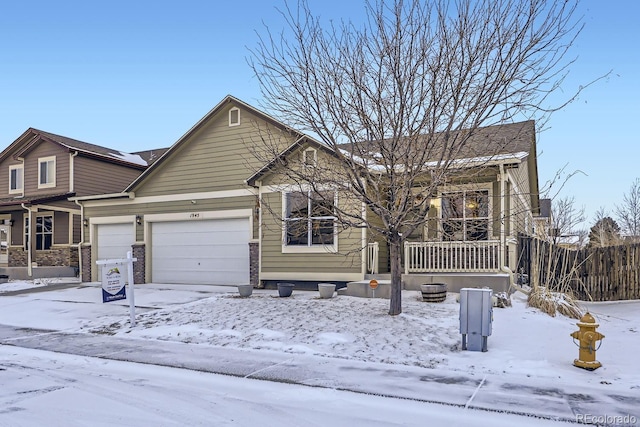 view of front facade with fence and an attached garage