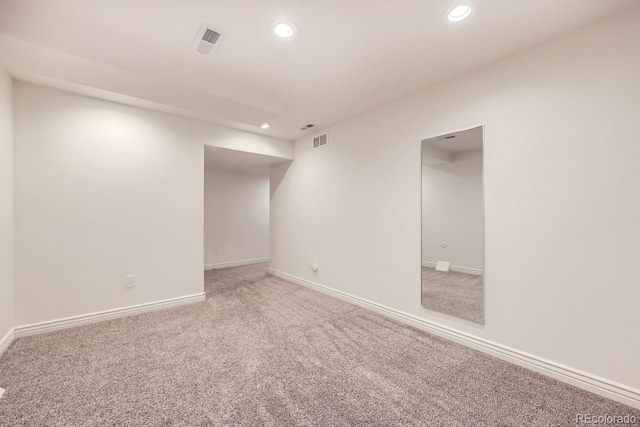 spare room featuring baseboards, carpet flooring, visible vents, and recessed lighting