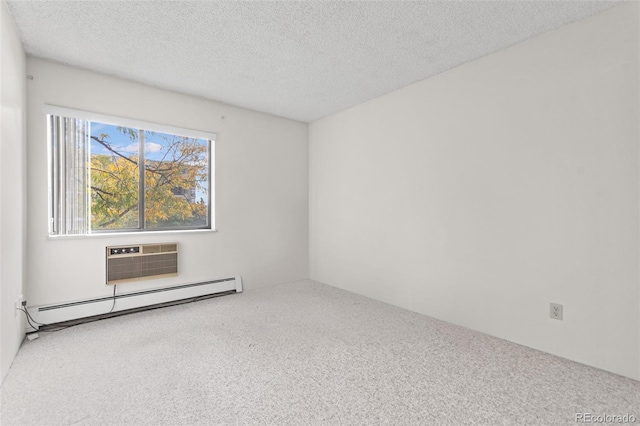 empty room with an AC wall unit, a textured ceiling, carpet floors, and baseboard heating