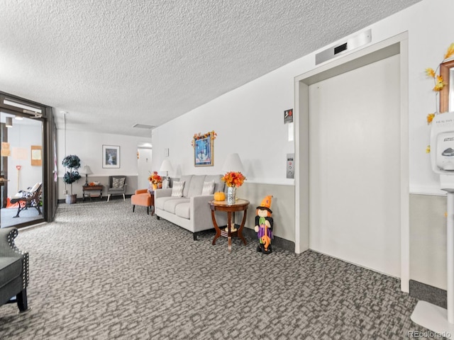 carpeted living room featuring a textured ceiling