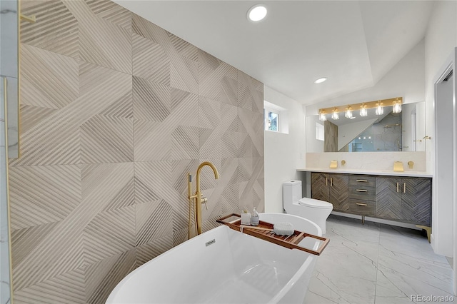 671 Elati St, Denver, CO 80204 - bathroom featuring vanity, toilet, a freestanding bath, marble look tiles, and recessed lighting