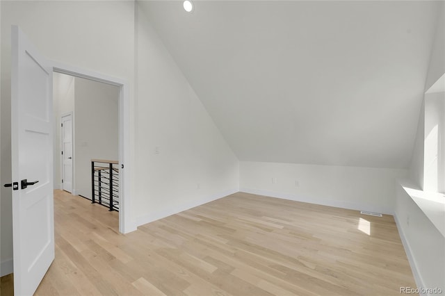 671 Elati St, Denver, CO 80204 - bonus room with lofted ceiling, light wood-style flooring, and baseboards