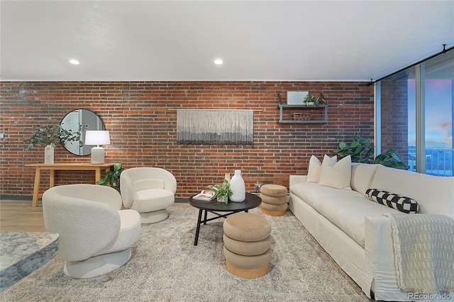 living room featuring recessed lighting, brick wall, and wood finished floors