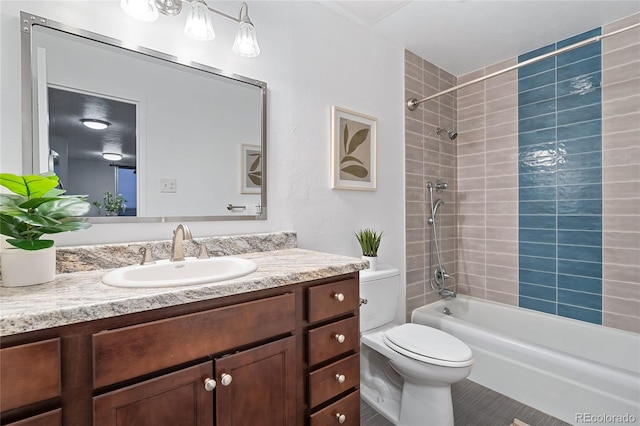 full bathroom featuring tub / shower combination, vanity, and toilet