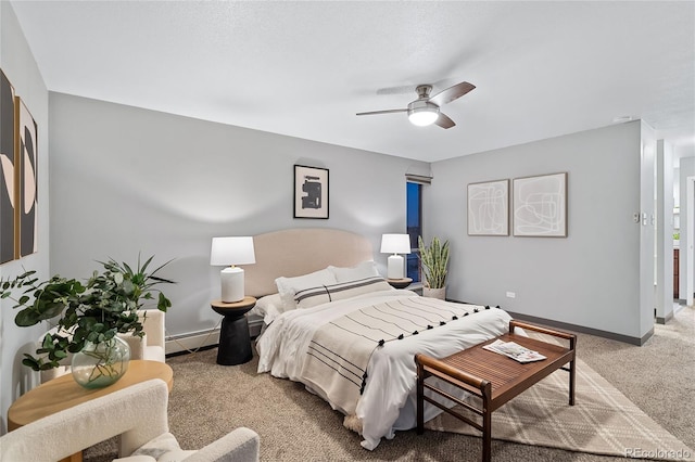 bedroom featuring carpet floors, a baseboard heating unit, ceiling fan, and baseboards