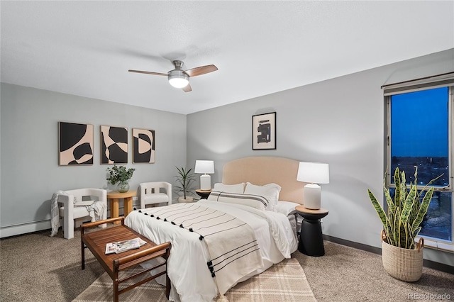 bedroom with a baseboard heating unit, carpet, baseboards, and a ceiling fan