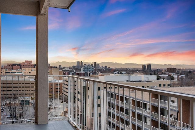 balcony featuring a mountain view and a city view