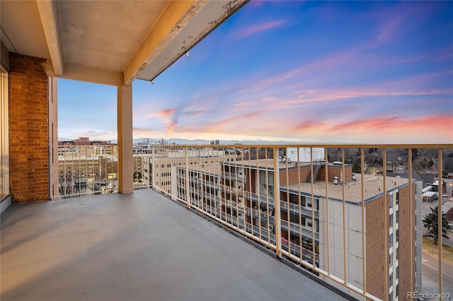 balcony at dusk with a view of city