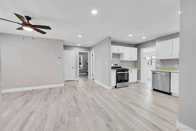 kitchen featuring white cabinetry, light wood-type flooring, ceiling fan, and appliances with stainless steel finishes