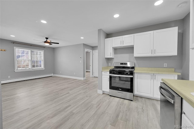 kitchen with light hardwood / wood-style flooring, baseboard heating, ceiling fan, stainless steel appliances, and white cabinets