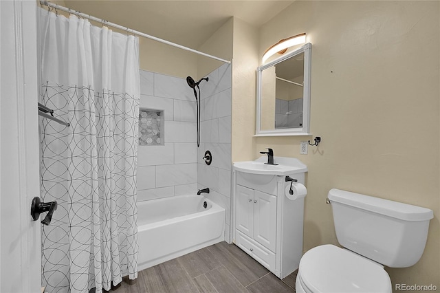 full bathroom featuring shower / tub combo with curtain, vanity, and toilet