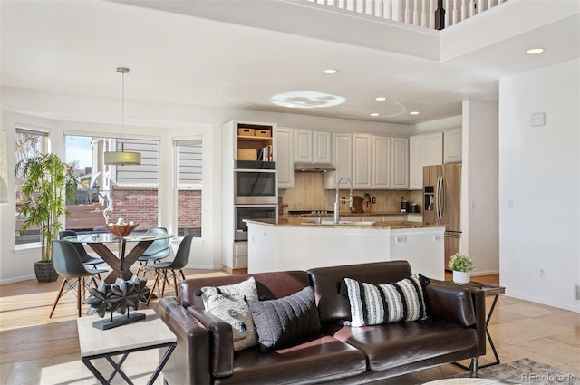 living room featuring sink and light wood-type flooring