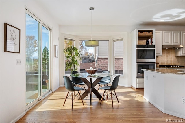 dining area with light wood-style flooring, baseboards, and recessed lighting
